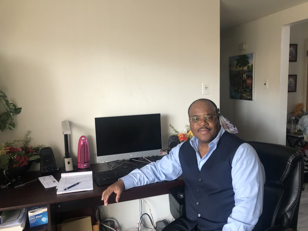 Jean Wilkins Paul at his bookkeeping desk